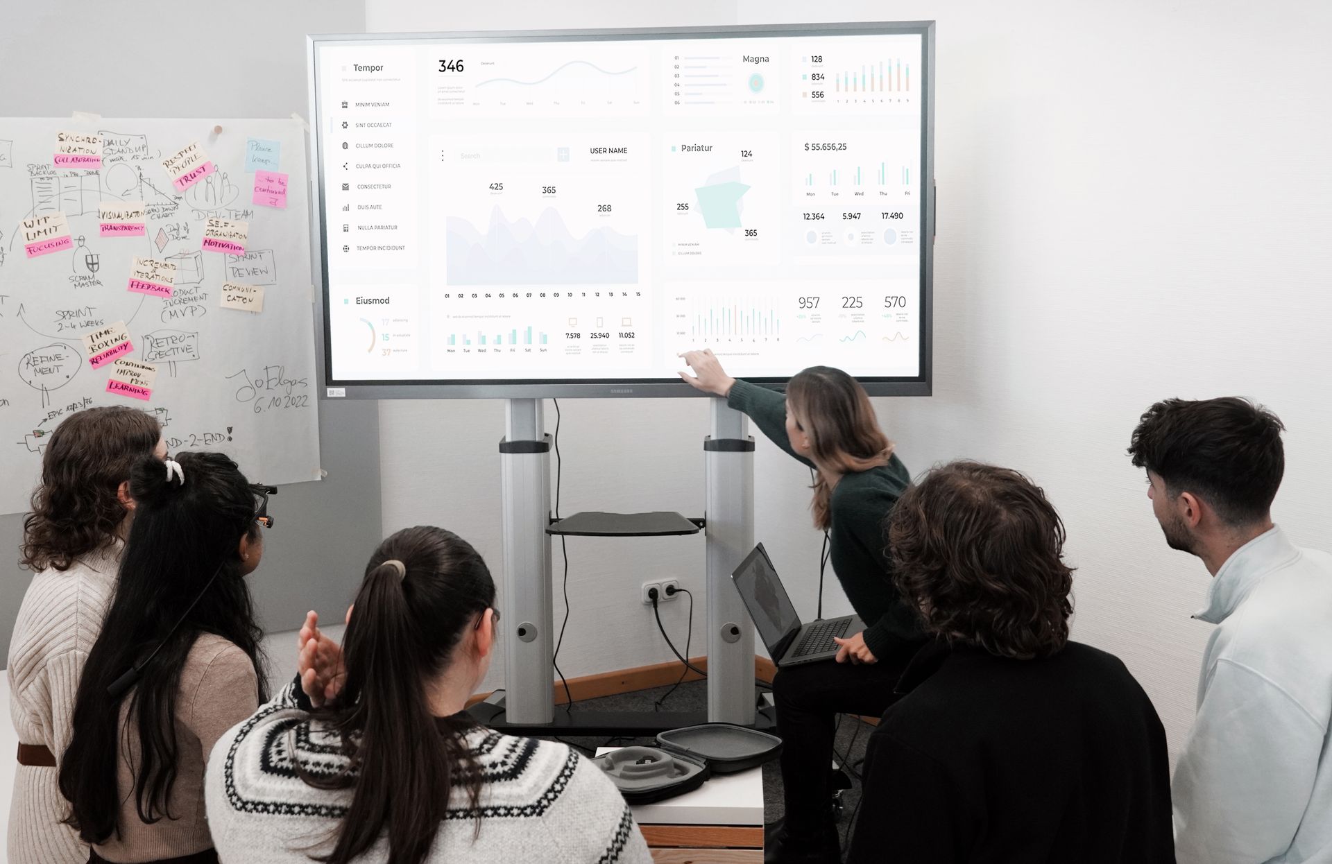 Consultants reviewing an AI-enabled delivery dashboard during a portfolio workshop